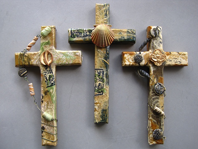collage covered wall crosses embellished with polymer clay symbols