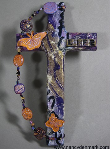 polymer clay symbols on collage cross by Patti Reed and Nancy Denmark
