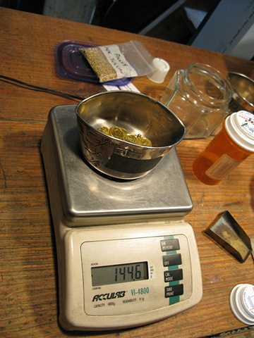 GOLD BEING WEIGHED FOR CASTING