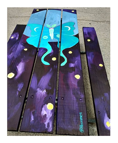 Painting of a lunar moth on a picnic table for the City of Iowa City by artist Katlynne Hummell Underhill