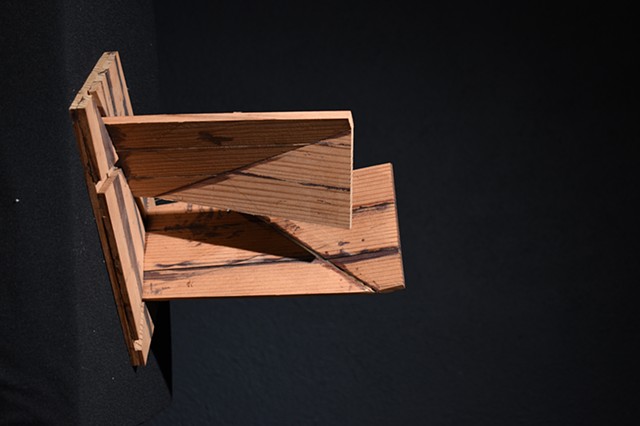 An abstract wood sculpture made with planes.