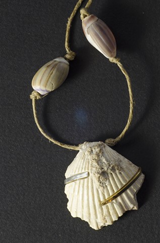 A fossil shell inlayed with sterling silver and brass by Ryan C Sedgeley.