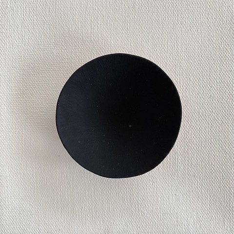 This painting/sculpture plays with a black paint that creates the illusion of a three dimensional object appearing flat. It also gives the viewer an "peek into a void" evoking whatever emotions come from staring into a void.. 