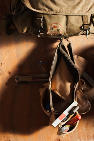 Here my camera bag is hanging with construction tool belts on the site of a natural building project. 