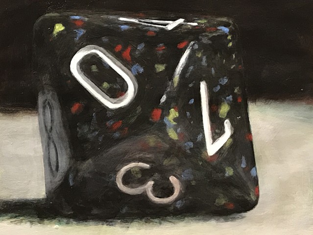 A black ten-sided dice, with red, blue, and yellow flecks is inked with white numerals. It rests on a felted neutral surface against a black background. 