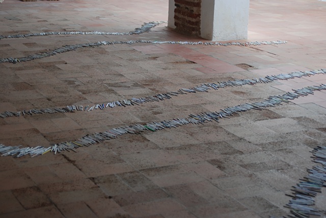 Exhibition Flying Carpet Prayers at El Psito, on the floor, rolled newspaper from Catalunya in the shape of Caadas Real