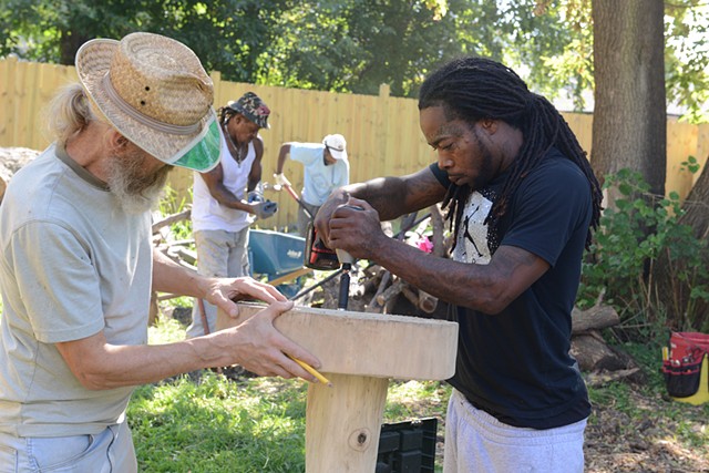 Vernon and Bryan connecting the table, Marvin and Gerald work in the background