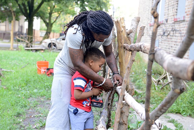 Vernon building a "branch fence" with his son