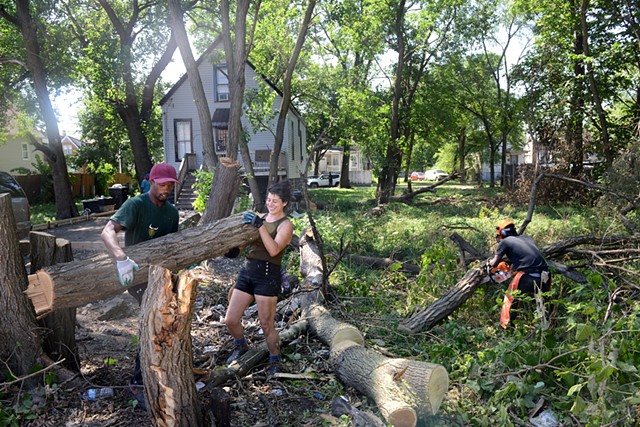 Sal and Lara reclaiming wood from a neighbor in Englewood