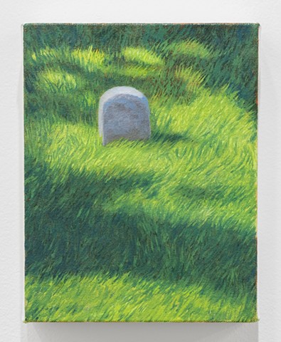 a grave in a grassy field