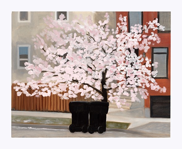 two black trash cans in front of a cherry tree covered in pink blossoms