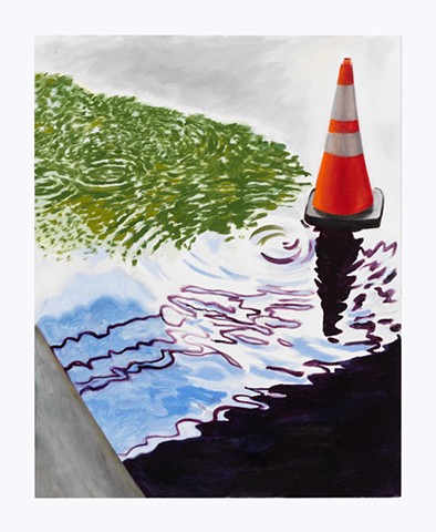 a puddle with an orange traffic cone