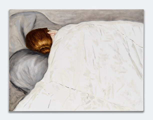 A woman napping under a white blanket
