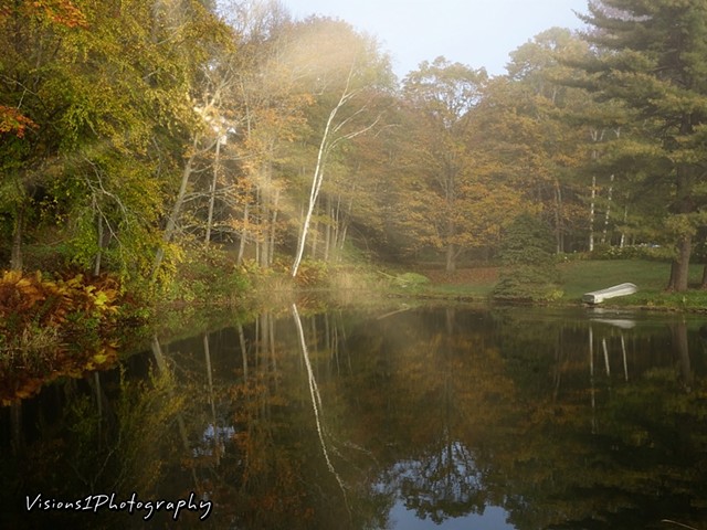 Small Pond with Fog and Sun Breaking Row Boat Thru Vt.