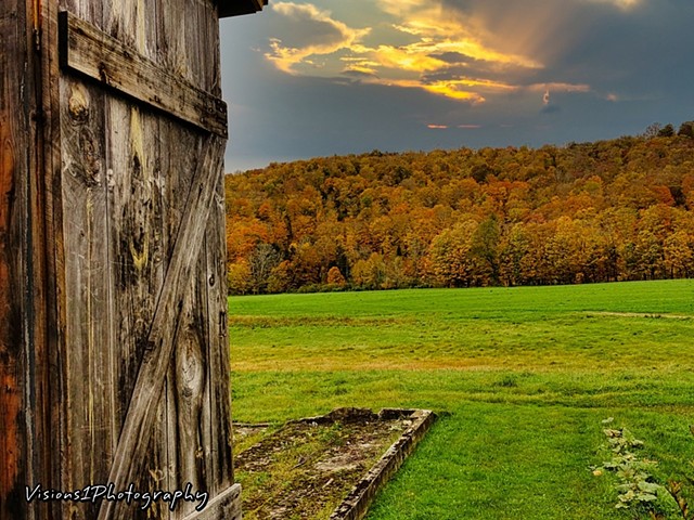 Side of Old Barn Door and Fall Trees at Sunset Vt
