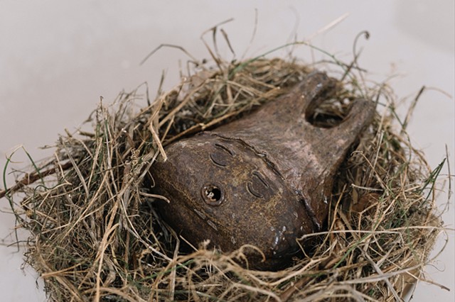 Sleeping Chestnut Baby, 2021 gas-fired stoneware clay, underglaze, glazes and nest made from found materials, dimensions variable