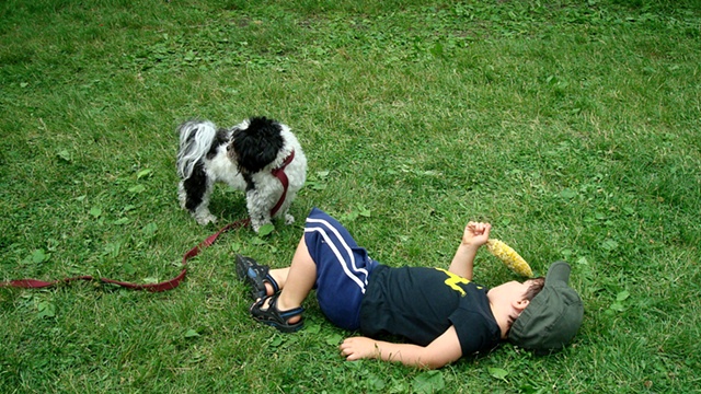 boy with elotes and dog