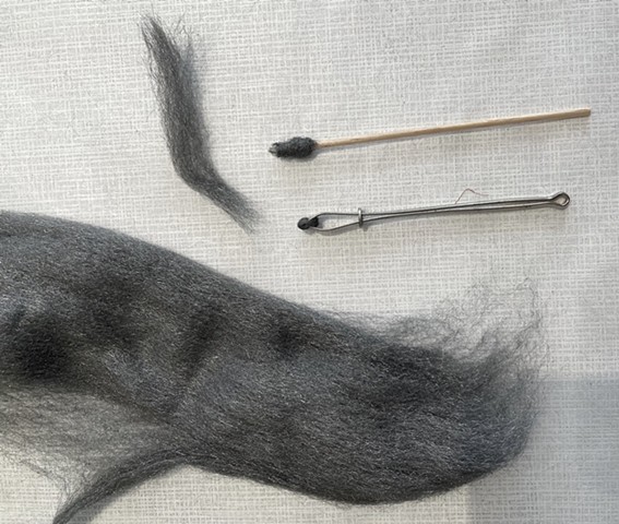 Steel wool pinched between tweezers and wound around cotton swab. Pinching with tweezers facilitated better control of the steel wool and was the method employed