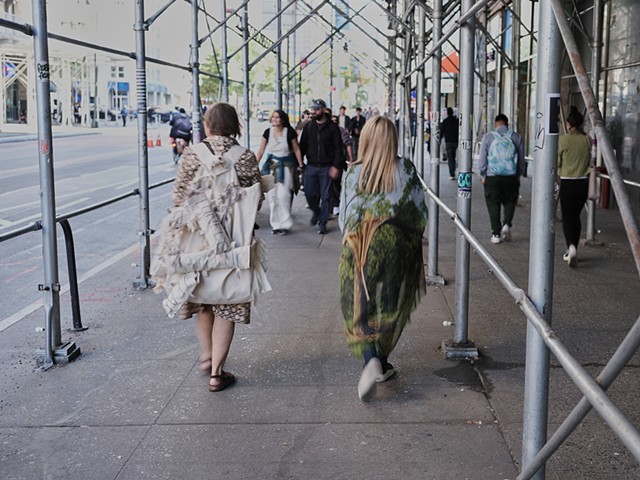 two artists under scaffolding 