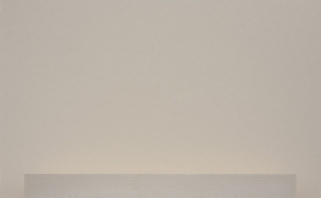 close-up of an edge of a book with a light stain on a plain background