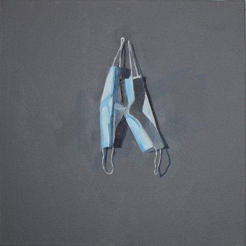 2 Blue Paper Masks on a Gray Wall