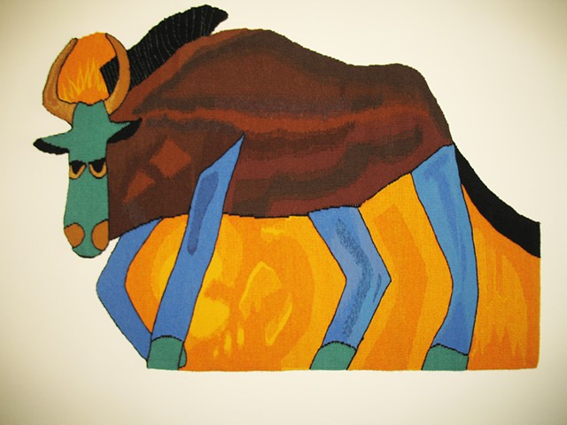 "Saul Alegria's 'A Wildebeest'" is a shaped, handwoven tapestry of wool on cotton.  45 in. x 39 in.  cotton. 
