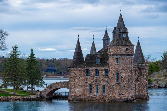 Stone Castle with a Bridge into Water and Sky