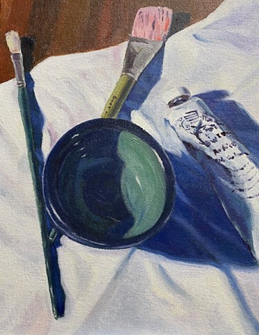 Still life with bowl, brushes, and tube of oil paint