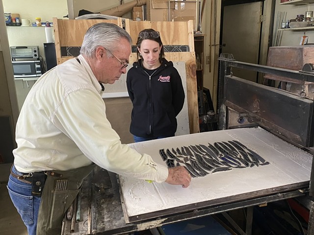 studio owner Kevin Ryan and his assistant load the gas kiln to fire the painted glass pieces, which bonds the paint to the glass.