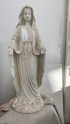 unpainted statue of Madonna