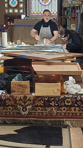 working on the light table, painting the glass