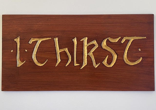carved wooden sign I made, which goes next to the completed statue