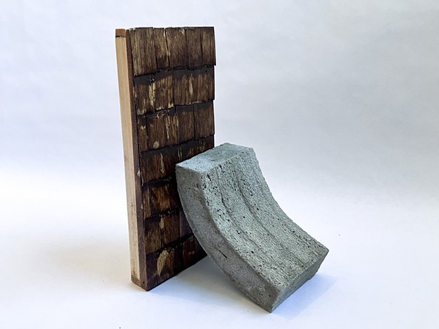 A concrete wall resting on a cedar wall: maquette for public sculpture