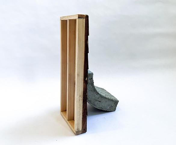 A concrete wall resting on a cedar wall: maquette for public sculpture