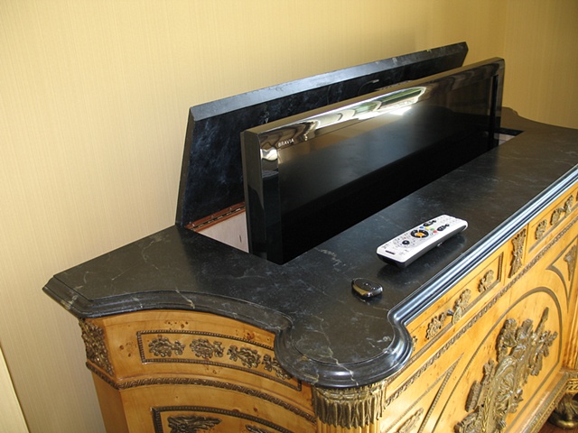 Custom wooden top painted in faux black marble and hinged to allow a modern tv to be accessed