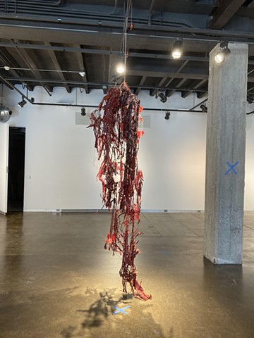 poultry wire, red sharpie on cardboard shreds, string, epoxy part A, silicone base