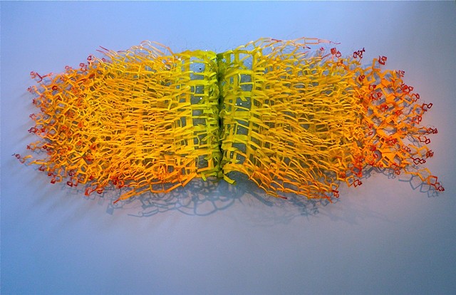 A contemporary wall sculpture made with cut and unfolded paper