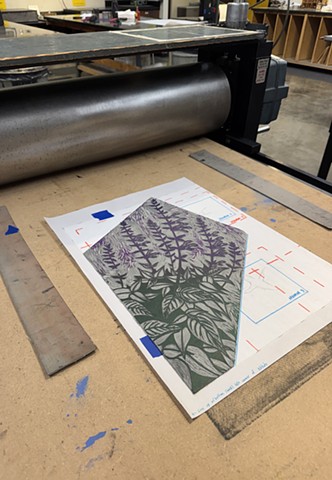 Carved linoleum block on press
