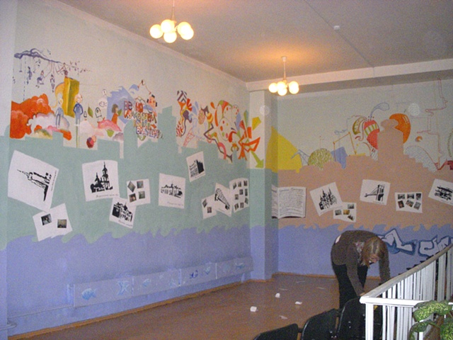 View from back of the room, with photos of the mural process added to "blank" book pages