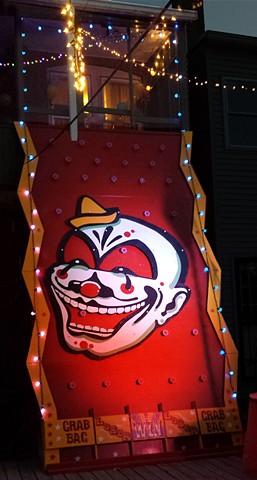 Giant backyard plinko game with clown face