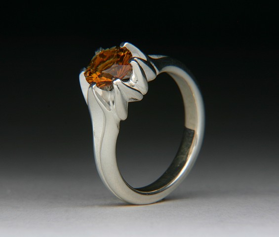 THE SMALL FULL LOTUS IS A DESIGN TWIST ON THE LARGER FULL LOTUS. IT IS THE EXACT SAME RING JUST SMALLER. THE MOUTNING IS DE-OX SILVER THAT DOESN'T TARNISH LIKE STERLING SILVER. SET WITH AN AMAZING MADERA ORANGE CITRINE. 