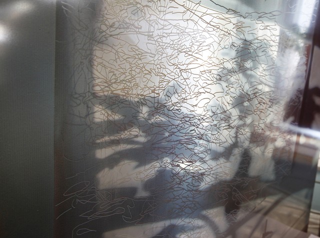 The White Layer of the shadow tracings from the canvas printed on the back of the glass as an opaqued layer. 