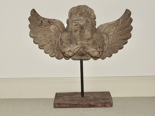 Carved wooden angel on metal base