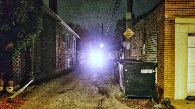 Alley with oncoming car