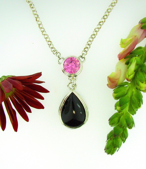Fabricated Sterling Silver pendant with 12mm round Pink CZ accent + a 25x18mm pear shaped Black Onyx cab. 