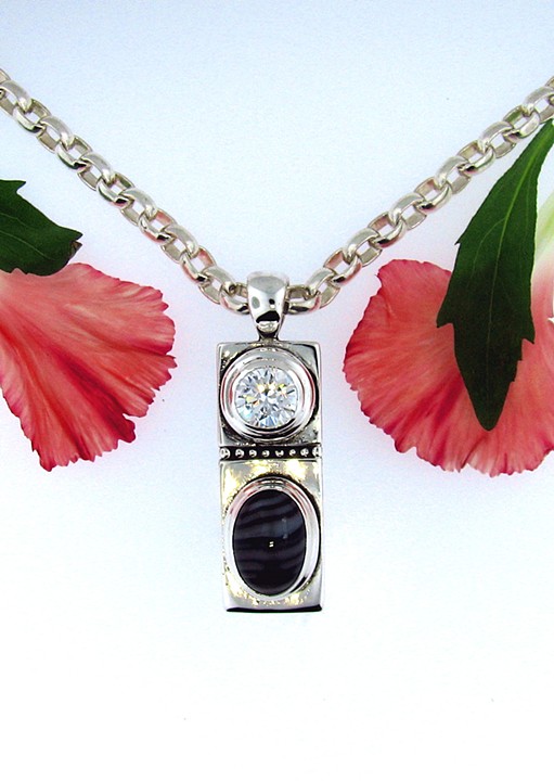 Sterling silver pendant with 8mm round cz + 14x10mm oval Banded Lace Agate accent. 18in. fox-tail chain.